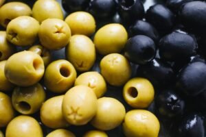 Close-up view of fresh green and black olives showing texture and color.